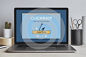 Clickbait concept on laptop screen on modern desk