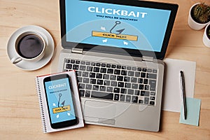 Clickbait concept on laptop and smartphone screen