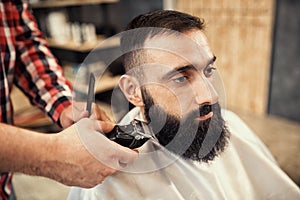 Client during beard and moustache grooming in barber