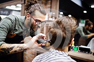 Client during beard and moustache grooming in barber shop