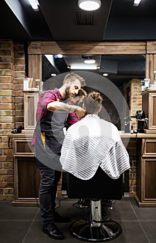 Client during beard and moustache grooming in barber shop