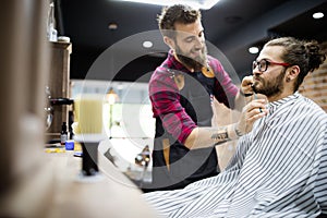 Client during beard and moustache grooming in barber shop