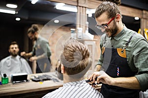 Client during beard and moustache grooming in barber shop