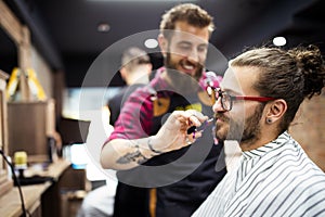 Client during beard and moustache grooming in barber shop