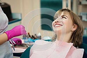 The client at the dentist`s office in the office smiles