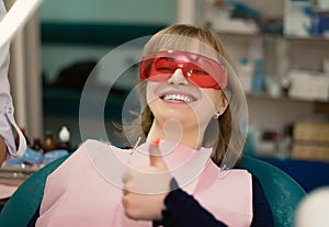 The client at the dentist`s office in the office smiles