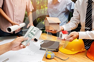 The client hires a construction company to build a house. Real estate concept. Home construction financing photo