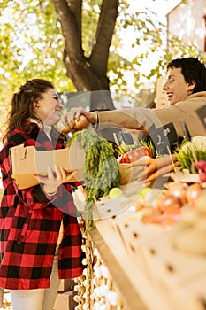 Client holding box of seasonal produce