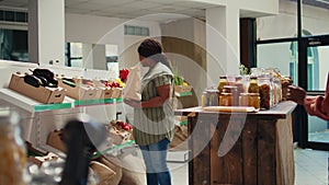 Client selecting bio fruits and veggies from market crates