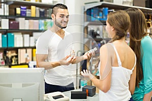 Client at shop paying at cash register desk