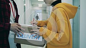 Client signs documents for the delivery of a parcel