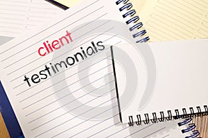 Client testimonials text concept on notebook