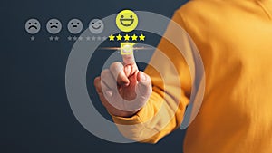 Client touching virtual screen on the happy smile face icon and five stars to give satisfaction in service.