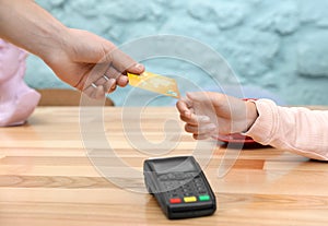 Client using credit card machine for non cash payment at table