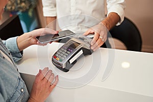 Woman paying with card contactless photo