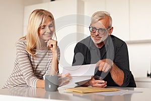 Clients rejoice at investment, financial profit. Family budget of pensioners, income. Mature husband and wife read a letter,