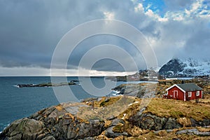 Clif with traditional red rorbu house on Lofoten Islands, Norway