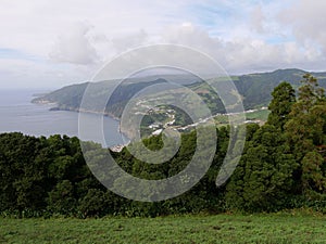 Cliff on the Atlantic ocean seen from the miradouro do Pico Longo in Azores photo