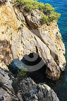 Cliff with a cave in the Costa Brava, Catalonia, Spain