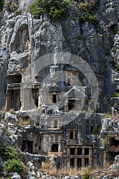 A cliff face covered in Lycian rock-cut tombs at the ancient site of Myra at Demre in Turkey.