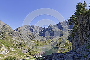 Cliff over the green mountain lake, Lac Longet photo