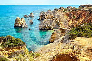 Cliff rocks and sea bay with turquoise water in Lagos, Algarve region, Portugal