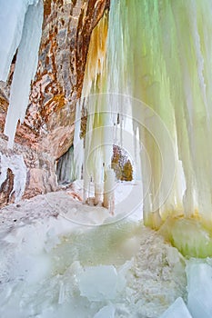 Cliff rocks with sheets of green ice from ground to ceiling