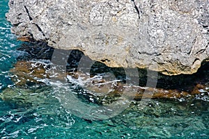 Cliff and seafoam closeup photo