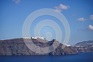 The cliff side of Santorini island and white houses on coastline