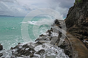 A cliff side walking path between Diniwid beach and White beach with rough wave at Boracay Island