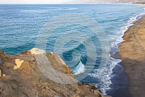 Cliff top view of california beach shoreline waves breaking into distance