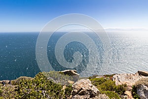 Cliff with vast horizon of the Atlantic Ocean in Southern Africa - calm sea