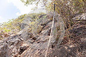 Cliff waiting for people to climb up with a rope to facilitate.