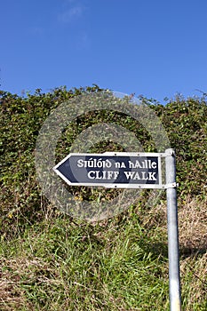 Cliff walk sign beside the cliffs