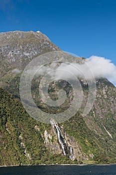 Cliff with waterfall in Milford Sound, New Zealand.