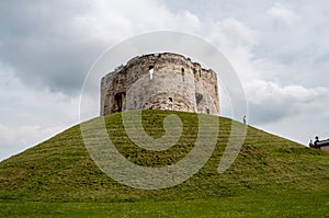 Clifford\'s Tower on a grassy hill in the city of York, England