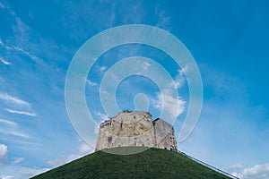 Clifford\'s Tower, the 13th-century castle keep, built on a grass mound, formerly used as a prison and royal mint photo