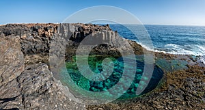 Cliffs aerials view of a natural pool in Caleta de Fuste photo