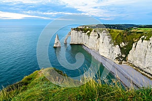 Cliffs Aval and Needle of Etretat and beautiful famous coastline during the tide. Normandy, France