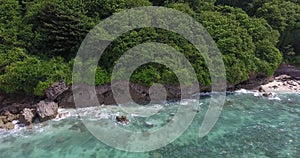 Cliffs of Bali island, massive rocks, lots of trees and blue ocean water, 4k