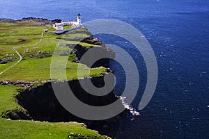 Cliffs, blue sea and lighthouse