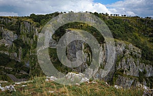 Cliffs of Cheddar Gorge from high viewpoint. High limestone cliffs in canyon in Mendip Hills in Somerset, England