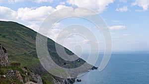 Cliffs of Co. Wicklow, Ireland overlooking Irish Sea, with rail tunnels cut into mountain.