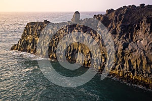 Cliffs on the coast of Lanzarote called Los Hervideros, during sunset