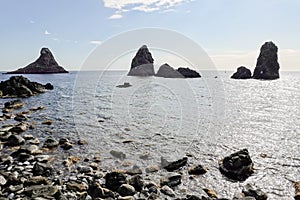 The cliffs of Cyclops Faraglioni dei Ciclopi near Aci Trezza town, Sicily, Large stones are believed to be thrown at Odysseus