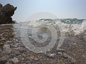 Cliffs, frothy waves lapping on the shore