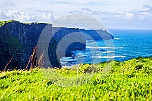 Cliffs of Moher at Alantic Ocean in Western Ireland with waves battering against the rocks