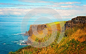 Cliffs of Moher by Atlantic Ocean in West Ireland with copy space.