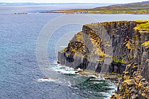 Cliffs of Moher with Doolin village and farm fields in background