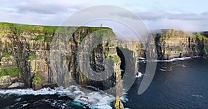 Cliffs of Moher shrouded in low clouds on a sunset 4k